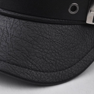 Detail shot of black PU leather beret showing pebble grain texture and metal eyelet buckle