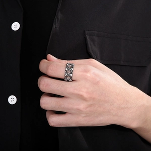 Close-up of a vintage hollow double skull ring in retro silver steel on a male model