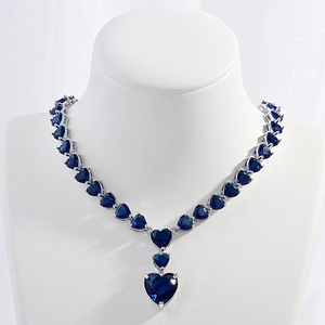 Elegant silver necklace featuring deep blue heart-shaped cubic zirconia gemstones