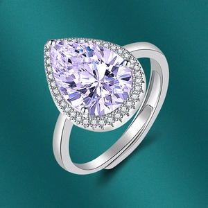 Close-up of a silver adjustable ring with pear-cut purple and clear cubic zirconia stones