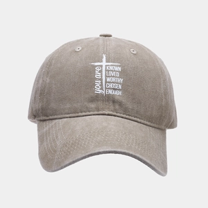 Washed khaki baseball cap with white cross and motivational quote for outdoor sports