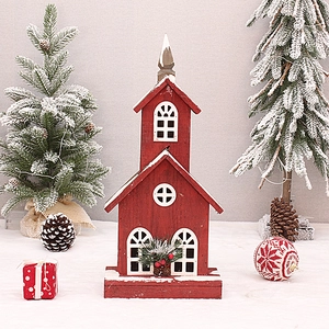 Red wooden church cabin decoration with pine cones and glowing snow effect for Christmas