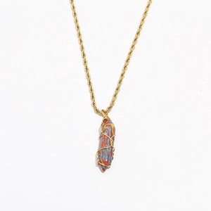 Detailed close-up of a bohemian turquoise pendant with golden twist chain necklace