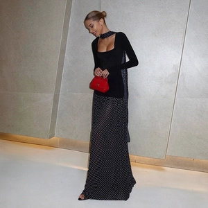 Detail of square neck polka dot dress with long sleeves and elegant pleated hem