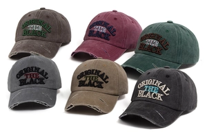 Close-up of distressed brim details and letter embroidery on vintage washed cotton caps