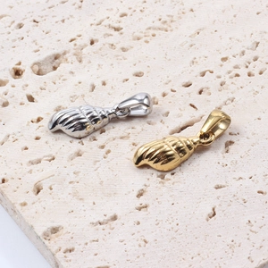 Polished shell pendant necklace in gold and silver finish on a textured stone base