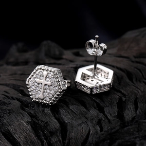 Silver hexagonal cross stud earring with zircon inlay on a textured black background