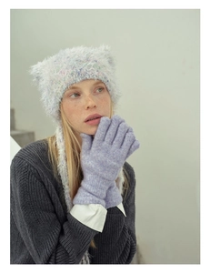Detail of wool blend knitted cat ear hat and soft purple gloves for winter warmth
