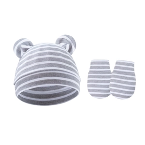 Detail of striped baby knit hat with cute bear ears and matching anti-scratch mittens set