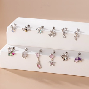 Detailed view of stainless steel cartilage studs with zircon bees, moons and hearts