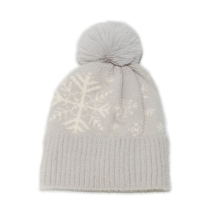 Detail of grey winter knit hat with white snowflake pattern and faux fur pompom ball