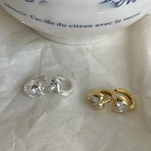 Macro shot of silver and gold S925 sterling silver heart earrings with cubic zirconia