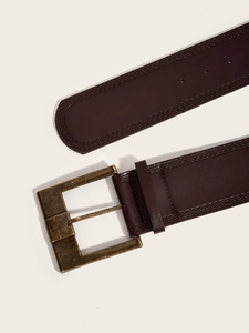 Detail of vintage dark brown leather belt with retro brass square buckle on white background