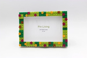 Close-up of DIY building block photo frame in green with star accents for 4x6 inch pictures