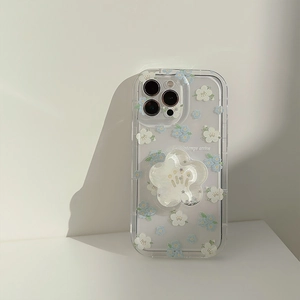 Detail view of transparent iPhone case with blue floral pattern and 3D flower stand
