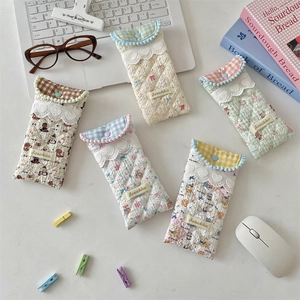 Five assorted quilted soft fabric eyewear pouches with floral patterns and lace trim