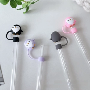 Close-up of penguin-shaped 10mm silicone straw covers in four colors with secure strap