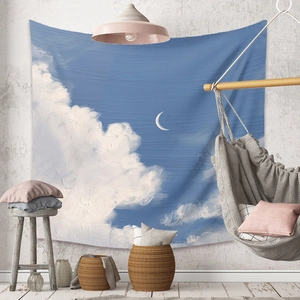 Artistic oil painting tapestry with blue sky and moon displayed in a modern cozy room