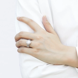 Detail shot of an oval zircon silver ring with a halo setting and triple-row pavé band