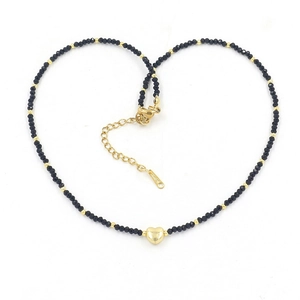 Detail of colorful mini crystal bead necklace with gold heart pendant and lobster clasp