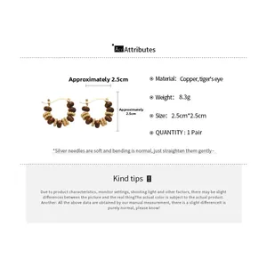 Detailed specs of tiger eye hoop earrings with copper beads and silver needles