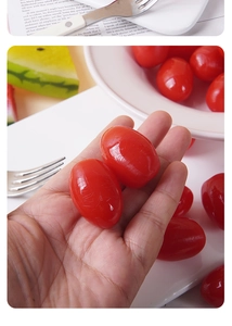 Macro detail of lifelike glossy red cherry tomato charms with realistic crystal texture