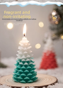 Detailed close-up of a gradient green Christmas tree candle on a wooden base decor