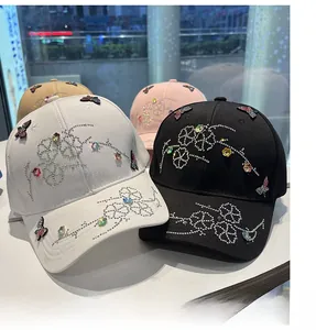 Detailed close-up of handmade rhinestone butterflies on colorful cotton baseball caps