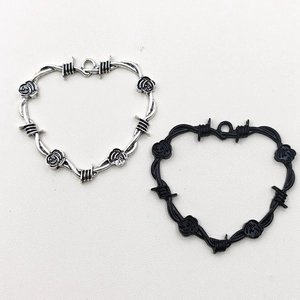 Antique silver and black heart charms with thorn wire design and rose flower accents