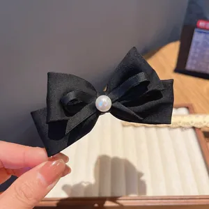 Elegant black satin bow hair clip with a center white pearl, vintage style ponytail holder