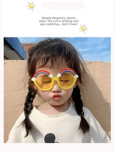 Detailed view of kids rainbow sunglasses featuring yellow lenses and cute cloud frames