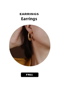 Close-up of golden beaded hoop earrings on model featuring a textured retro style