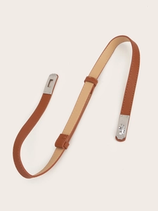 Detail of caramel brown waist belt with silver buckle and cross-grain texture