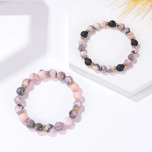 8mm Pink Zebra and Volcanic stone beaded bracelets with golden spacers on white blocks