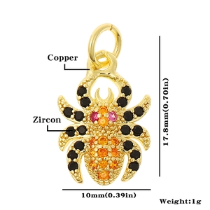 Macro detail of a 17.8mm gold spider pendant crafted from copper with colorful zircons