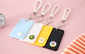Detailed view of colorful push-pull card holders with braided wrist straps and floral charms