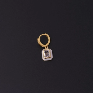 Detail of a gold-plated earring featuring white enamel pendant and clear zircon inlay