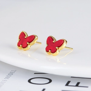 Close-up of red butterfly stud earrings with gold beaded edges on white background