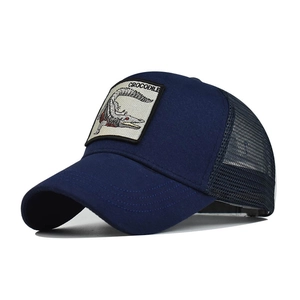 Detail of navy blue trucker hat with embroidered crocodile patch and breathable mesh back