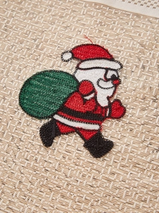 Close-up of Santa Claus embroidery on beige linen fabric for Christmas home decor