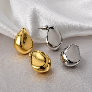 Chic 18K gold and silver plated teardrop stud earrings on white silk background