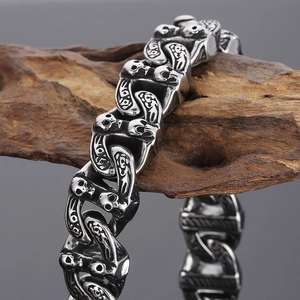 Gothic silver skull link bracelet in stainless steel on natural wood background