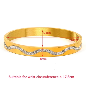 Golden wave pattern stainless steel bangle with crystals and 5.3x6.3cm size dimensions