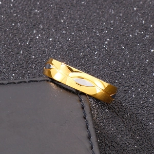 Macro shot of gold 18k plated titanium ring with geometric patterns on black leather