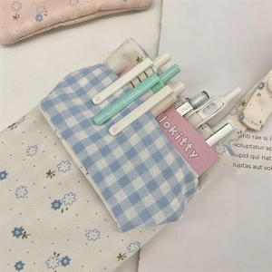 Close-up of a floral nurse pocket protector showing double-layer storage and blue patterns