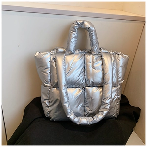 Detailed view of silver quilted tote bag featuring metallic finish and soft padded grid