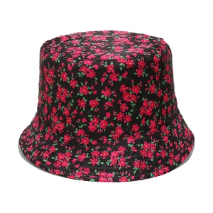Detailed close-up of high-density red floral pattern on black canvas bucket hat