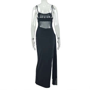 Detail of slim fit black maxi dress featuring sheer mesh waist and high side slit