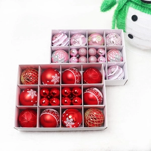 Set of 12 festive red and pink Christmas balls with various patterns in a white gift box