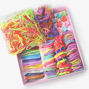 Close-up of colorful hair accessory set with elastics and clips in pink storage box